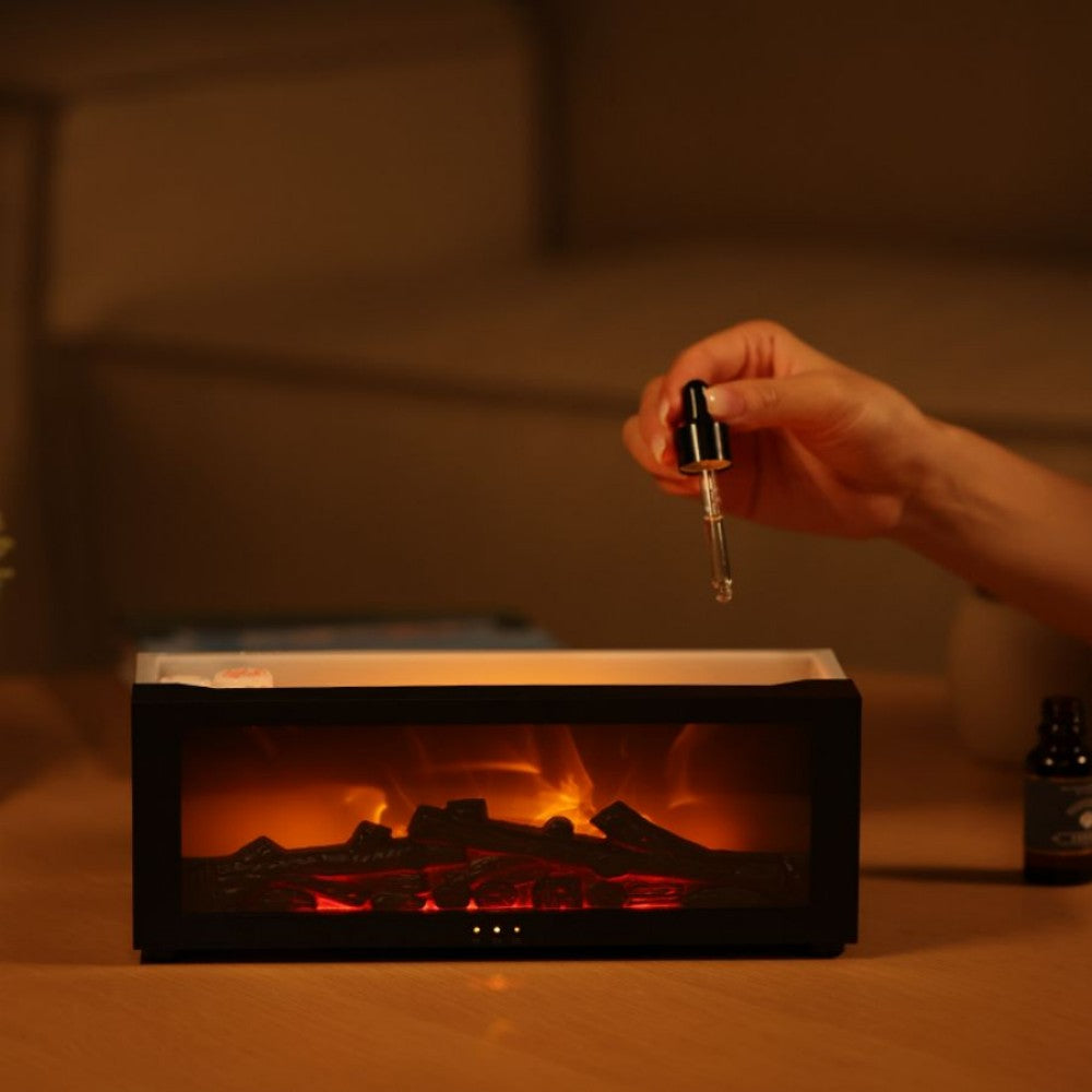 Adding essential oil to the flame aromatherapy diffuser's water tank with a dropper