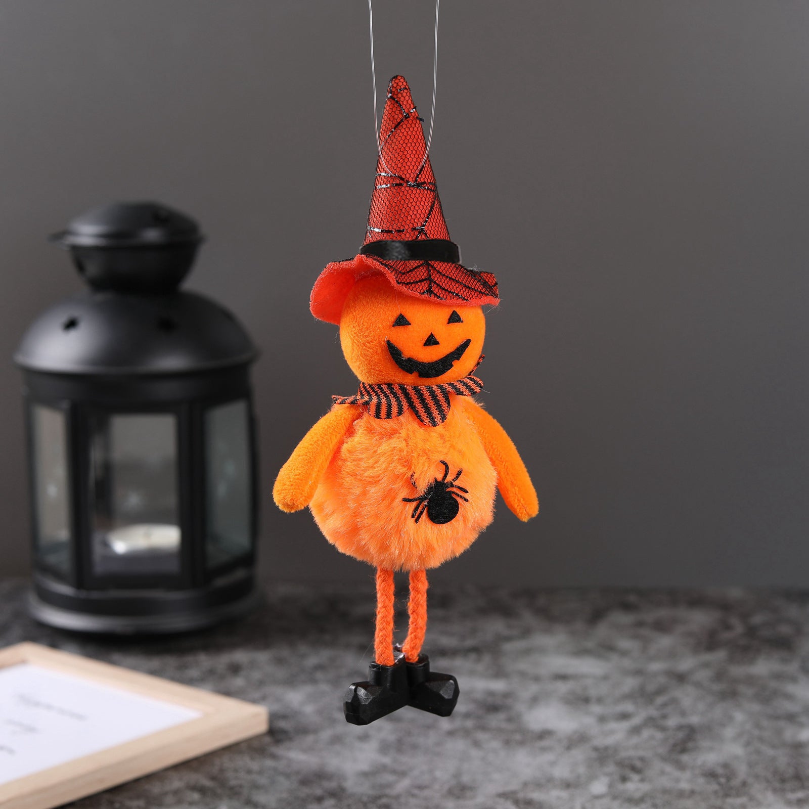 Pumpkin style Halloween hanging pendant in a seasonal display setting