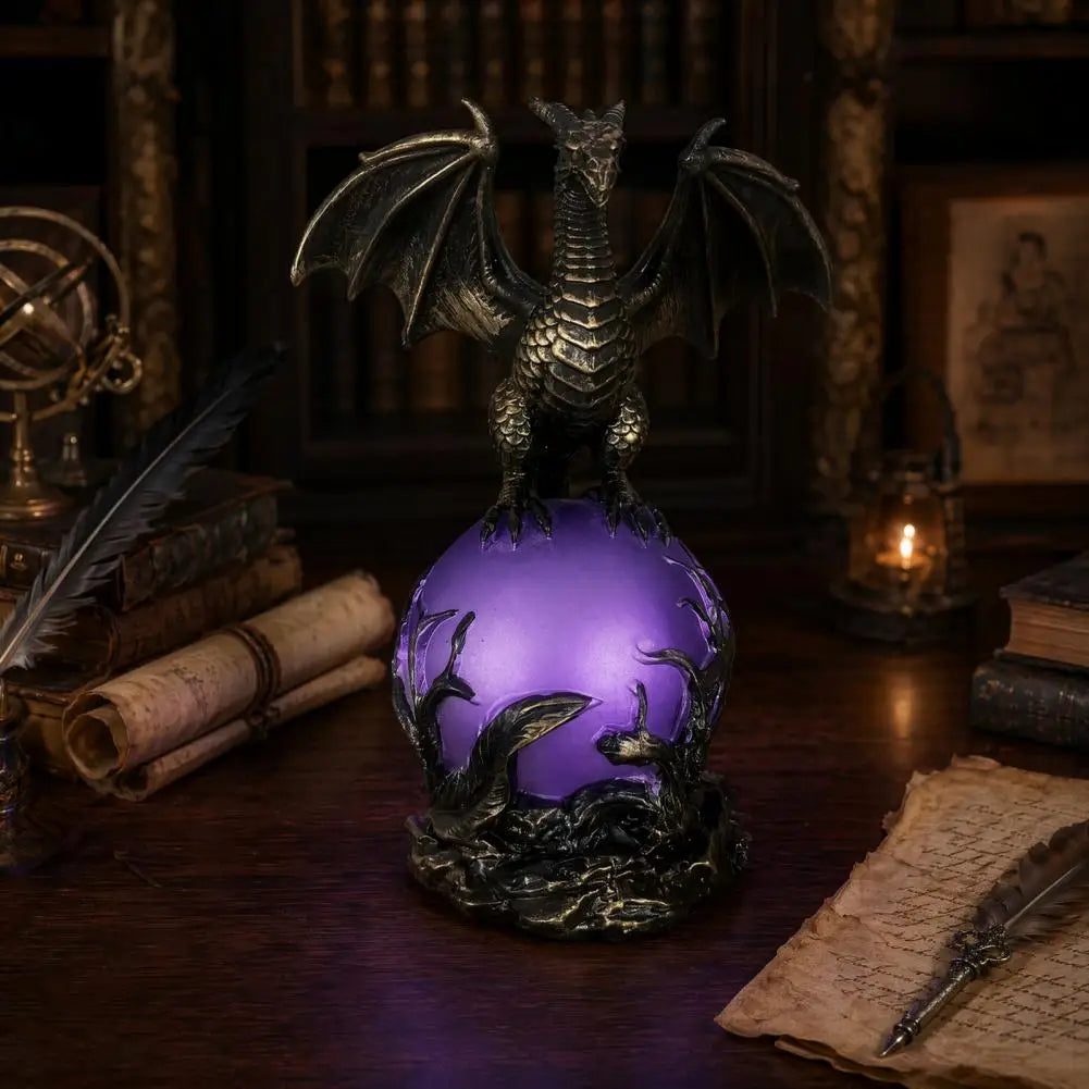 Dragon orb lamp glowing purple on a desk with books, a quill and a lantern