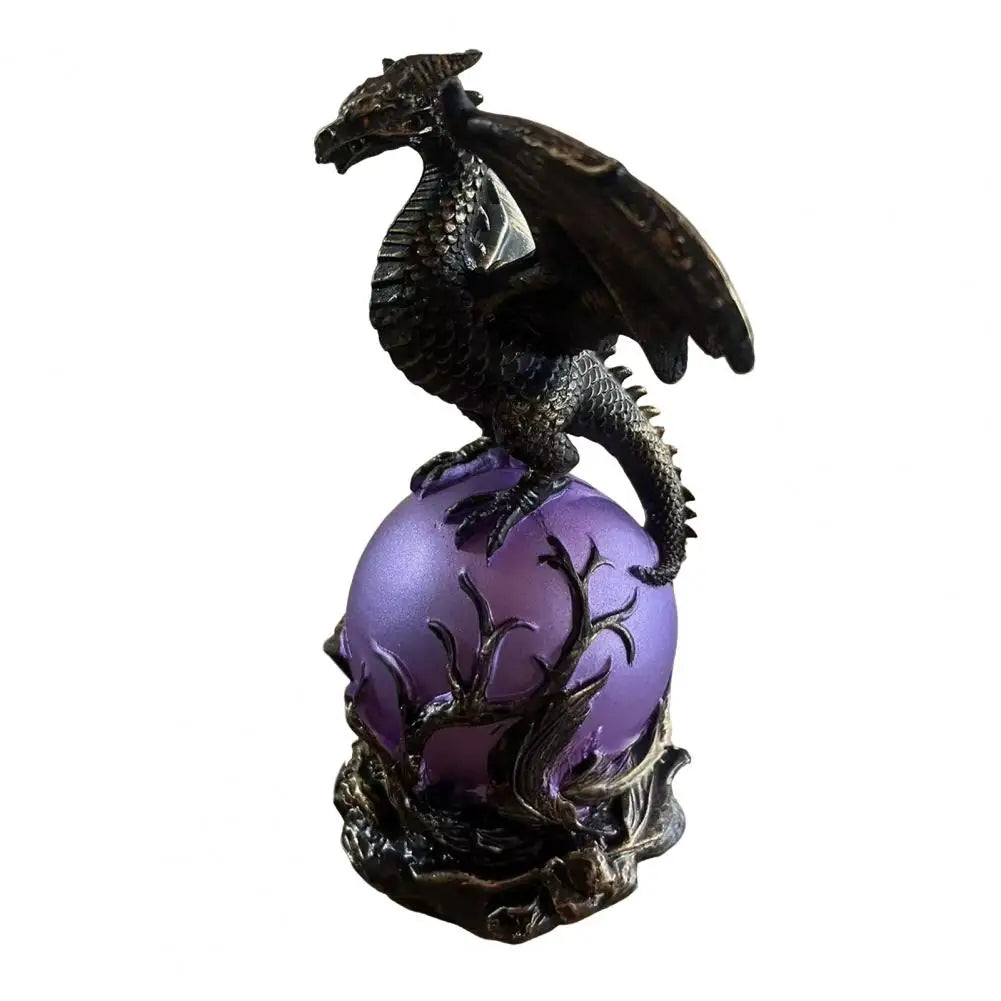 Bronze dragon figurine perched on a glowing purple orb lamp