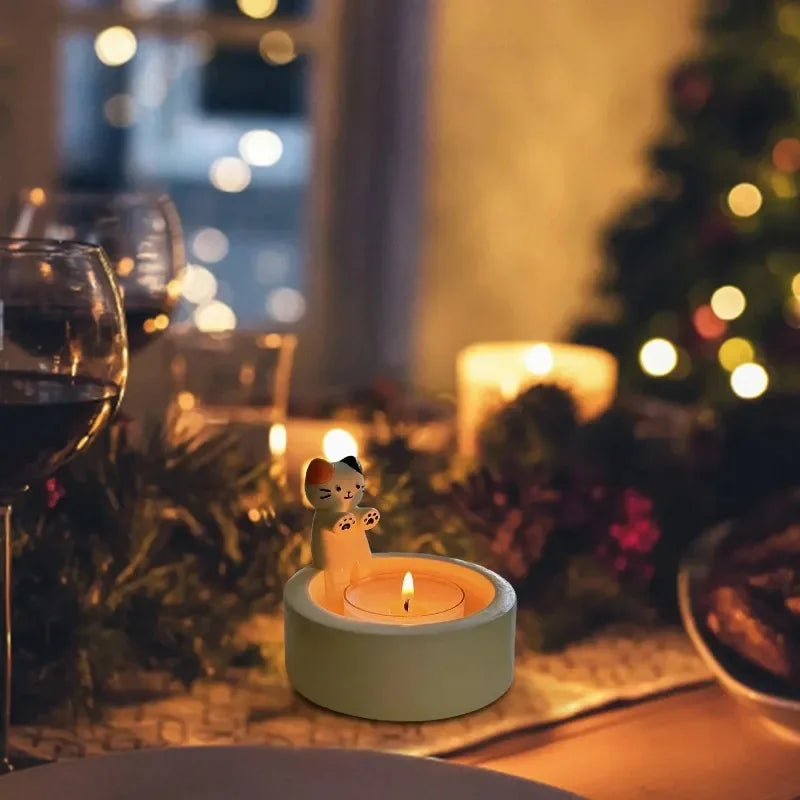 Cat tealight candle holder glowing on a festive holiday table setting