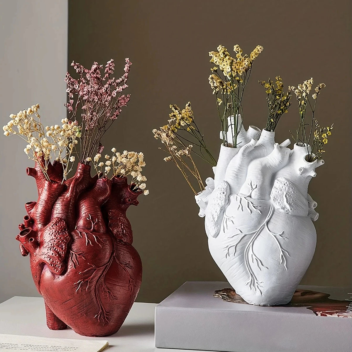 Anatomical Heart Sculptural Resin Vase in Red and White, shown side by side with dried flower stems