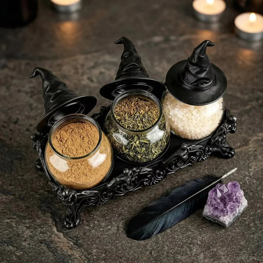 Witch hat spice jars filled with cinnamon, dried herbs and coarse salt beside candles