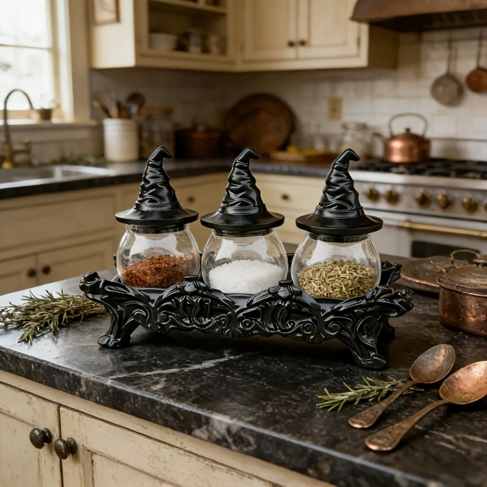 Witch hat spice jars filled with spices on a marble kitchen counter with copper spoons