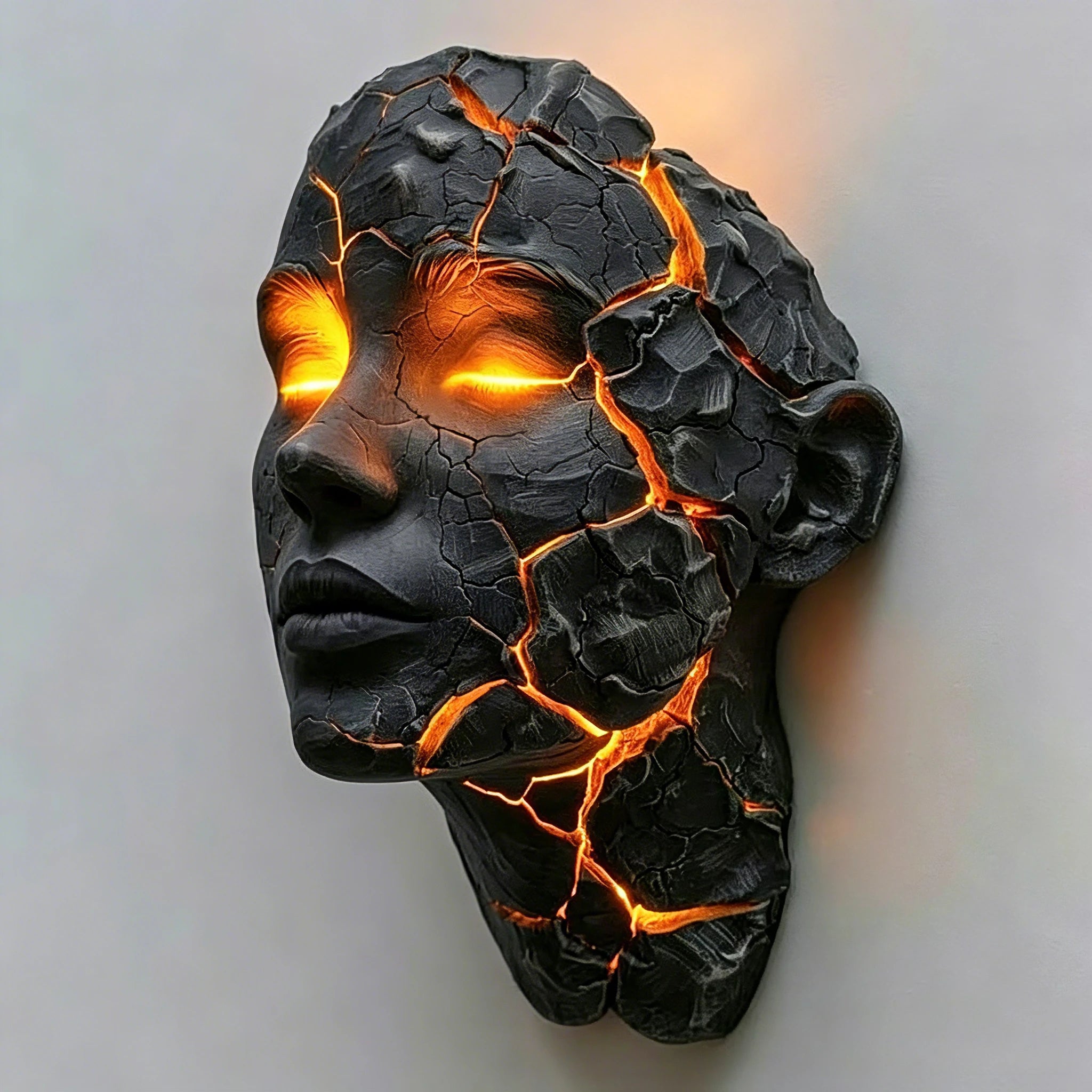 Close-up of a cracked black face wall light with glowing orange eyes and fissures