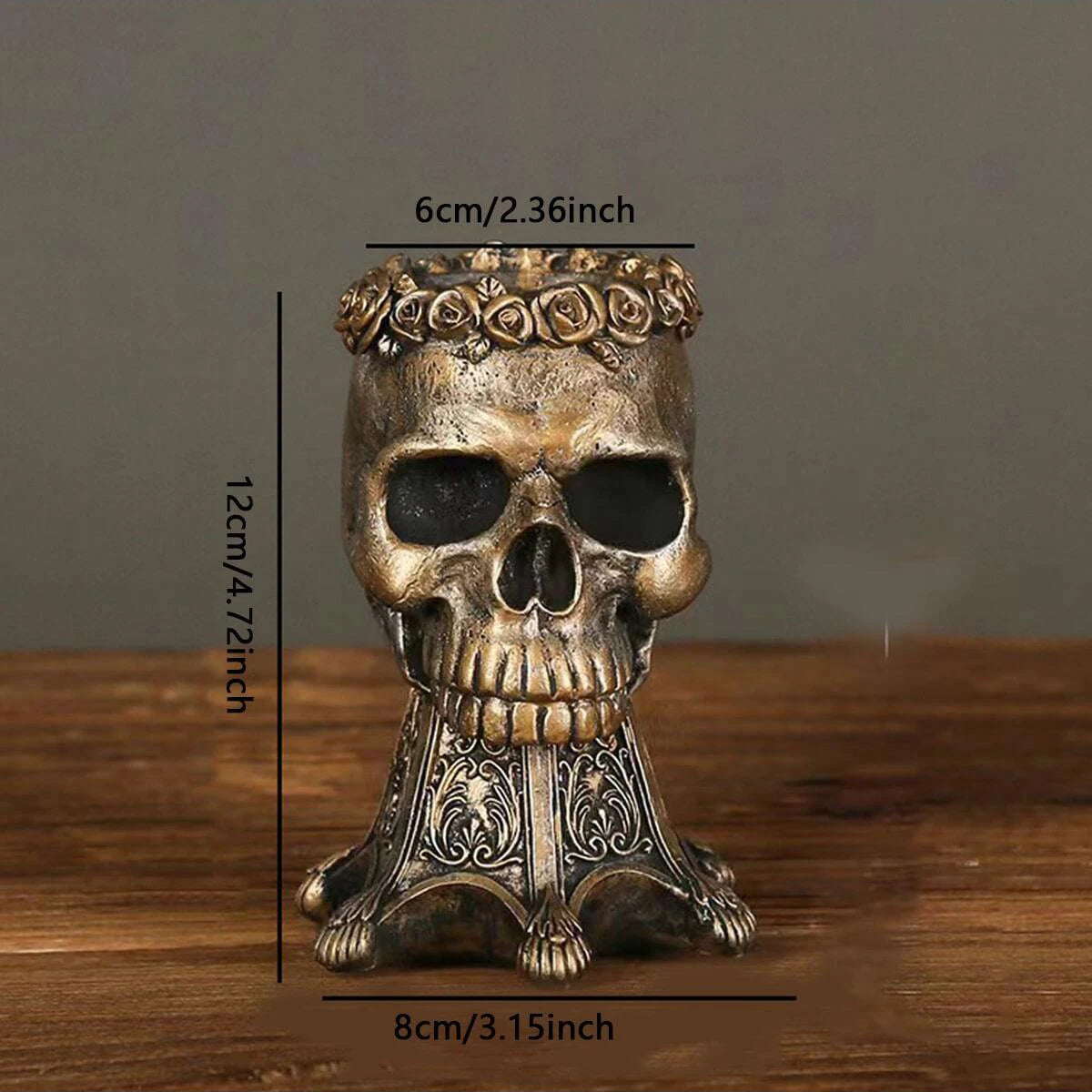 Two bronze gothic skull vases with red roses side by side