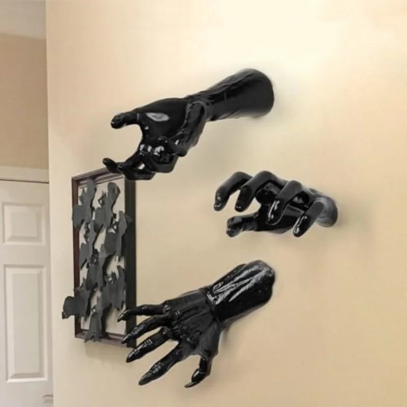 Three black clawed wall-mounted hands reaching out from a hallway wall