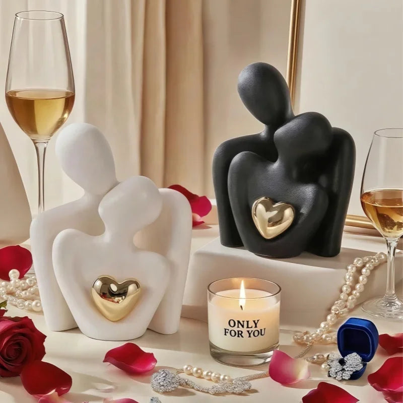 Black and white Modern Couple Embrace ceramic figurines with gold heart accents styled with candles and wine glasses