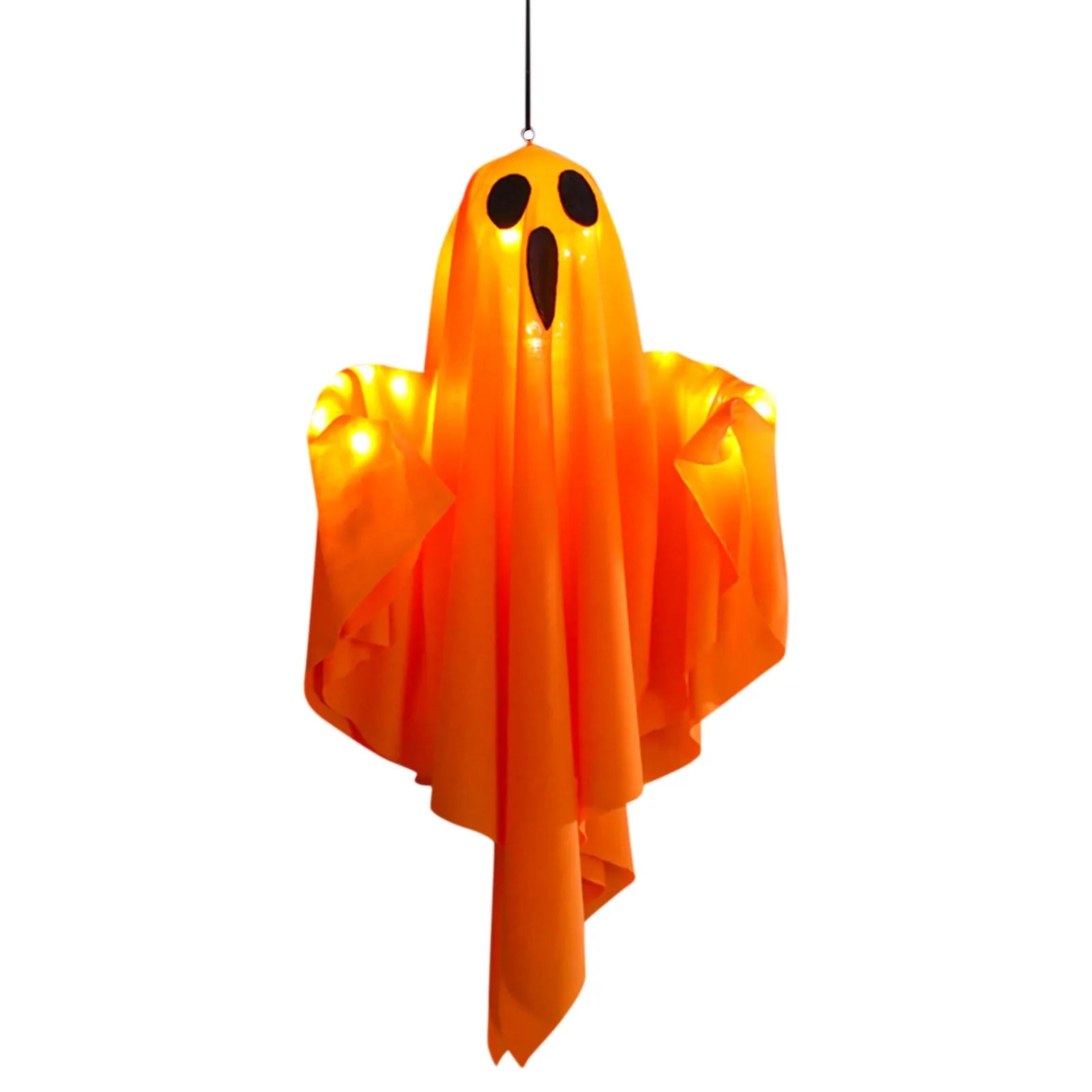 Glowing white fabric ghost hanging above a table with a jack-o'-lantern and lit candles