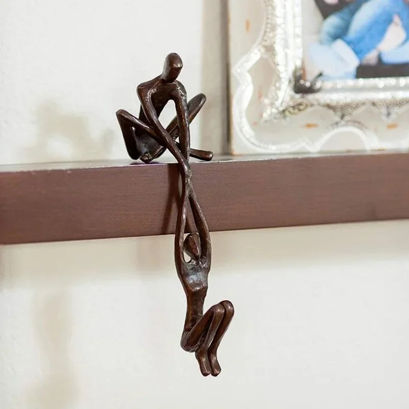 Man lifting woman balance sculpture, bronze-tone resin, additional product view