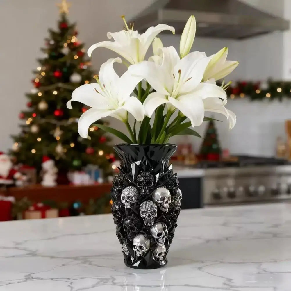 Skull resin vase holding white lilies with a Christmas tree in the background