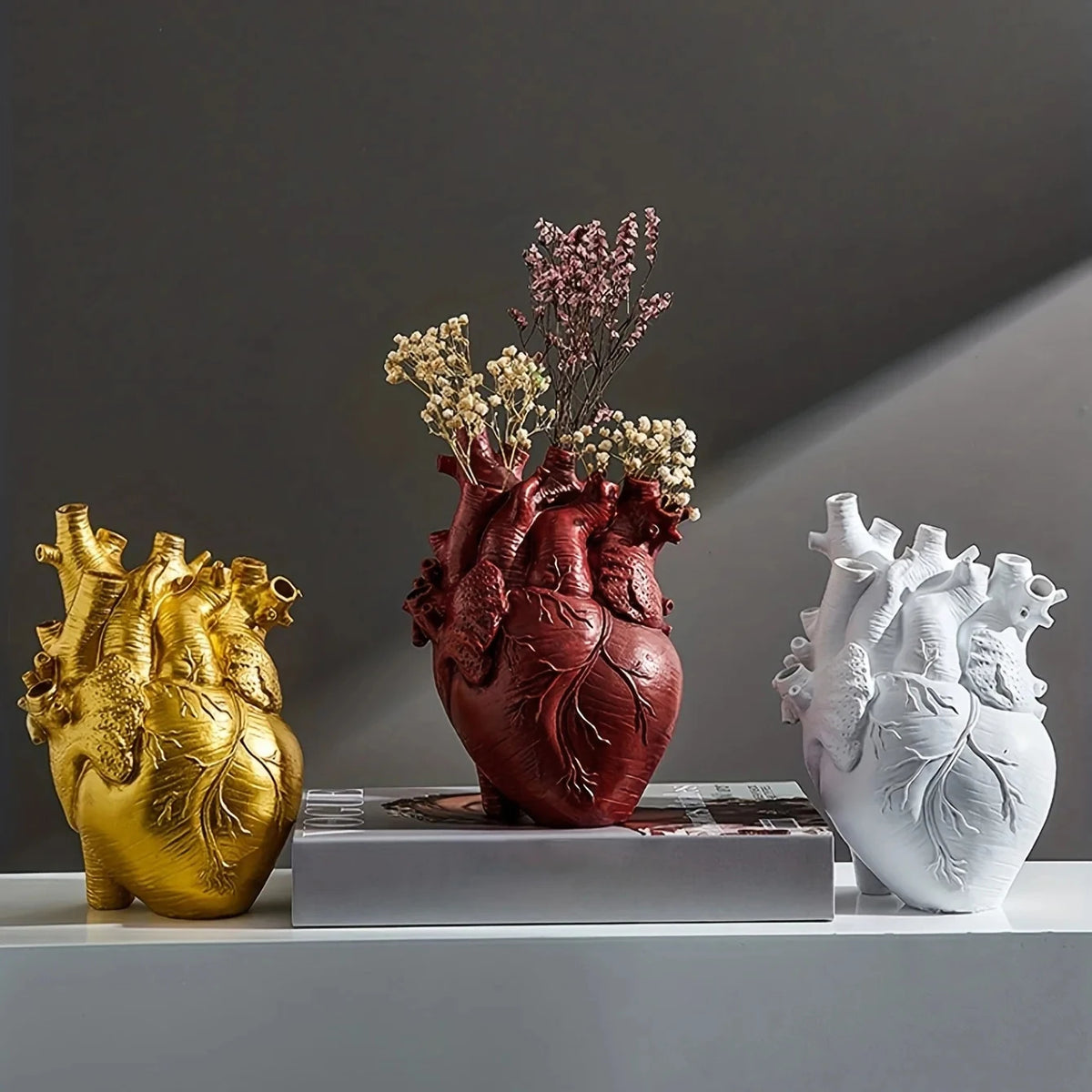 Anatomical Heart Sculptural Resin Vase styled on a tabletop with faux florals
