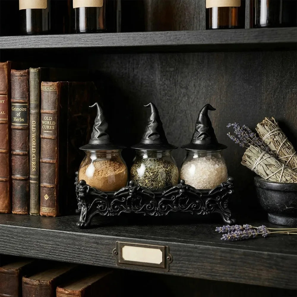 Witch hat spice jars displayed on a bookshelf next to old books and dried sage