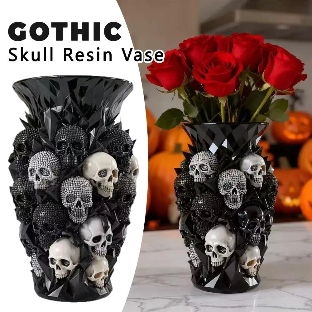 Skull resin vase holding red roses beside carved pumpkins