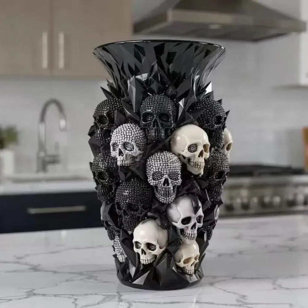 Skull-covered black resin vase displayed on a marble kitchen counter
