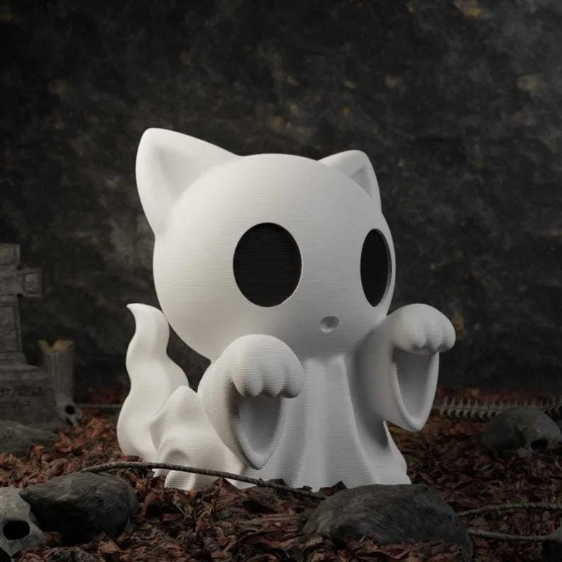 White ghost-shaped cat figurine with raised paws displayed outdoors