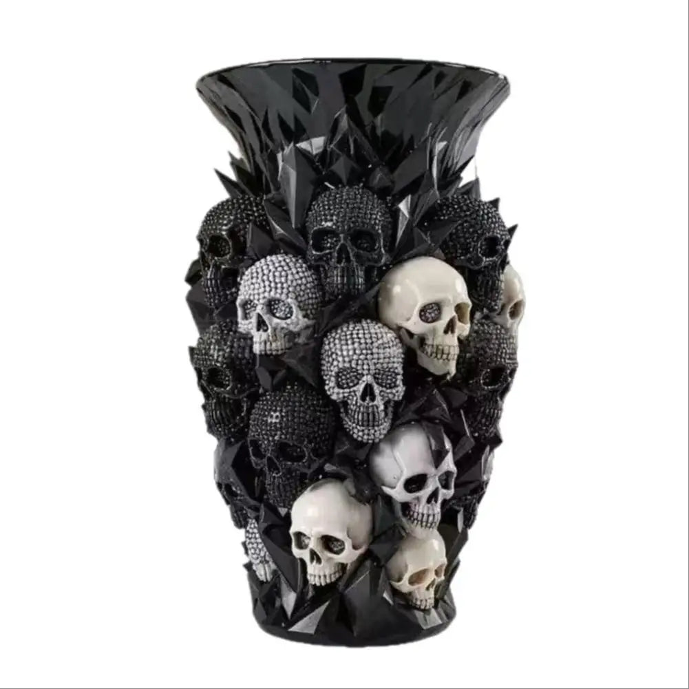 Black resin vase covered in black, silver and white skull sculptures on white background