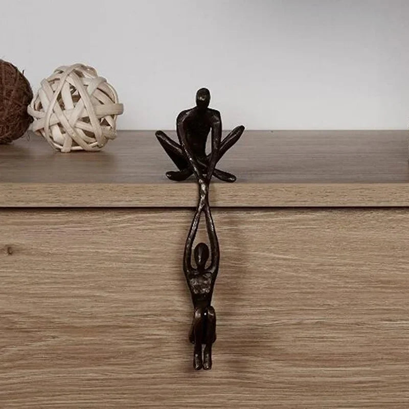 Man lifting woman balance sculpture, bronze-tone resin, additional product view