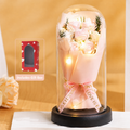Eternal Rose Glass Dome styled on a nightstand with an open book, warm ambient light